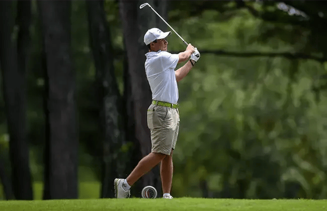 young professional male golfer teeing off