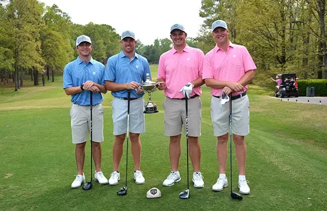 young professional men golfers standing with trophy